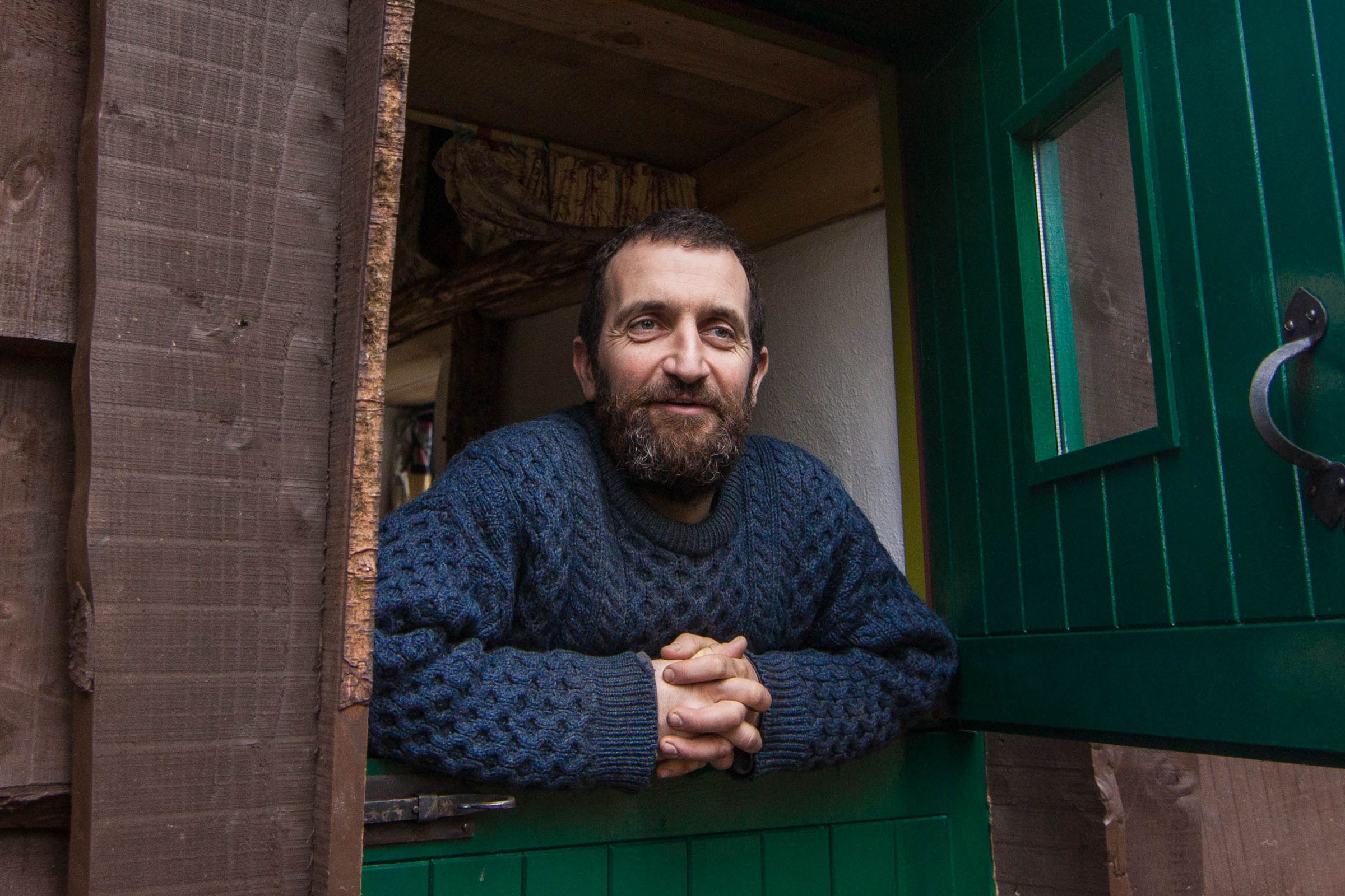 Mark Boyle leaning on the half-door of his home in the west of Ireland